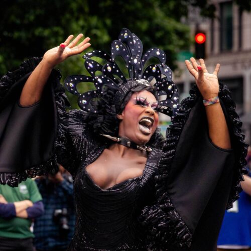 Joyful woman in all black reminiscent of a bird